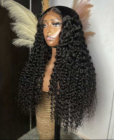 A mannequin head displaying a wig with deep wave hair texture and a 5/5 mini frontal hairline.